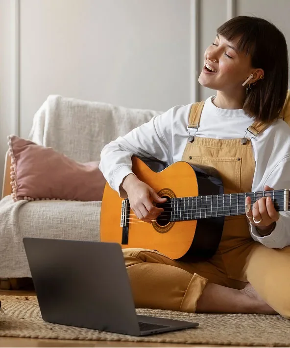 A woman learning acoustic guitar at home