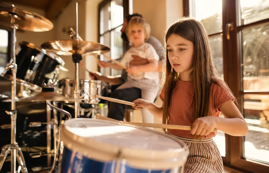 Children practising on a drum kit