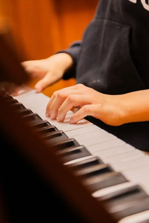 A young pianist practising at a keyboard