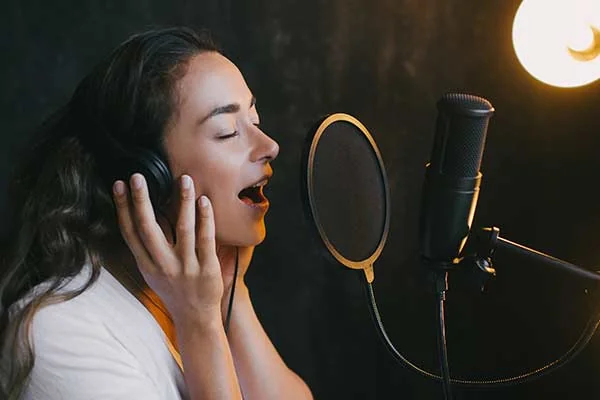 A young singer practising with a microphone